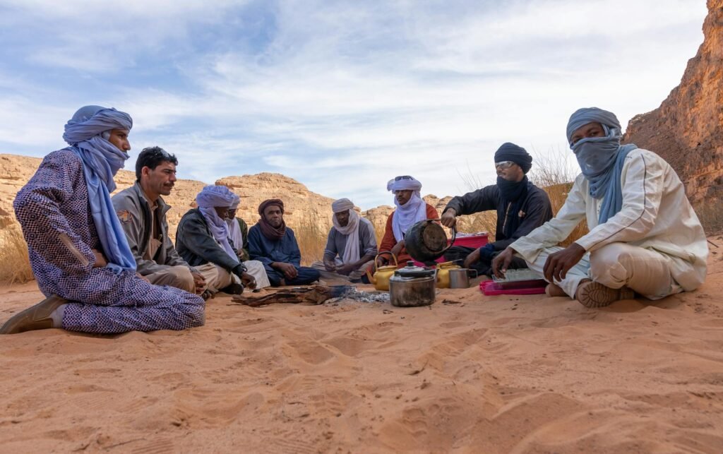 group of people sitting on sand