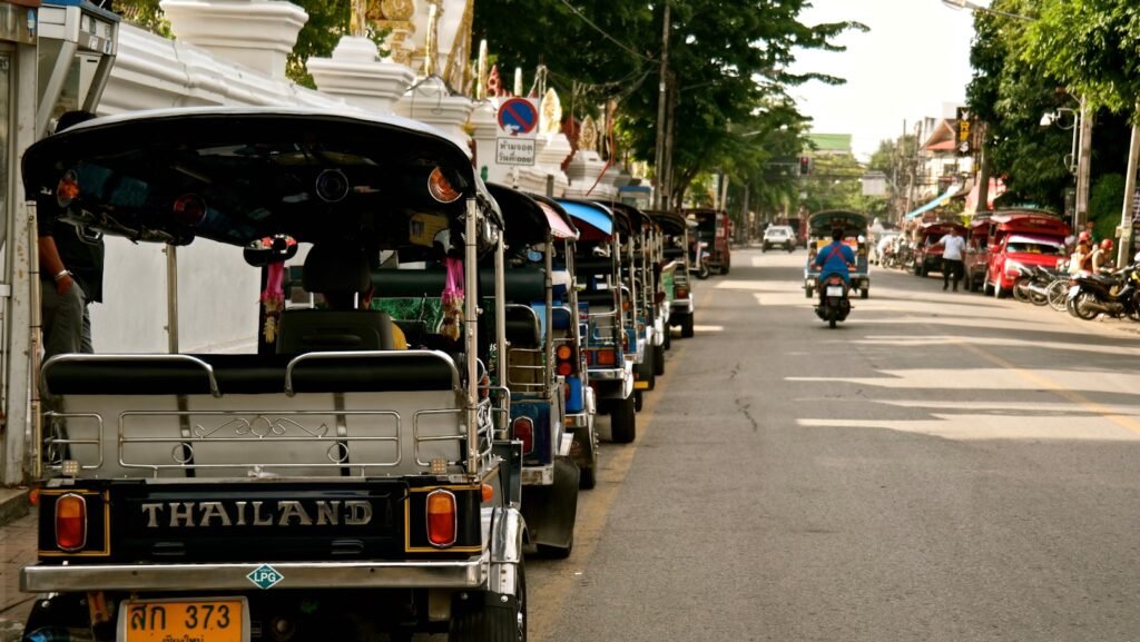 people riding on a bus during daytime - tuk tuk en Thaïlande