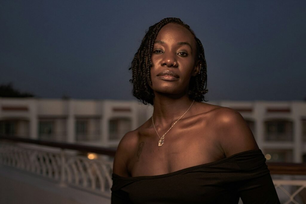 A woman standing on a bridge at night